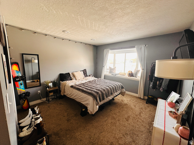 1559 Riverside Avenue, Unit 9 Provo, UT 84604 - Photo 5 of 12 Carpeted bedroom featuring baseboards and a textured ceiling