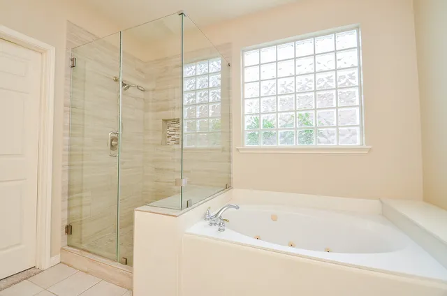 a bathroom with a bath tub and shower