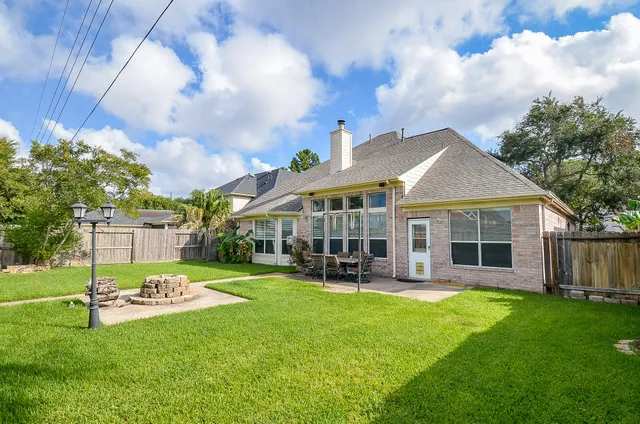 a front view of a house with a yard table and chairs