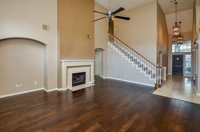 a view of a livingroom with wooden floor and a fireplace