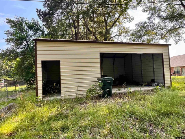 a view of house with backyard space and garden