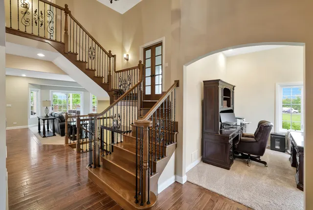 a view of entryway livingroom and hall with wooden floor