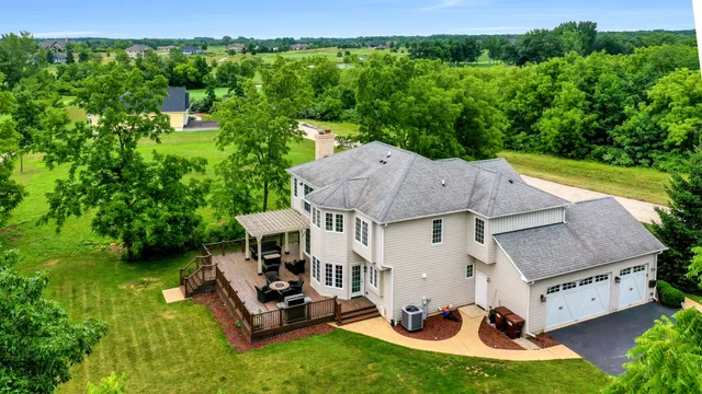 an aerial view of a house with swimming pool garden view and a yard