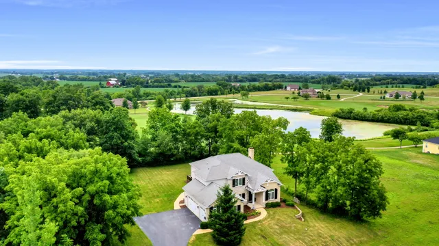 an aerial view of a houses with outdoor space and swimming pool