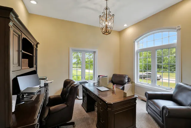 a view of a livingroom with workspace and a window