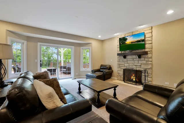 a living room with furniture a flat screen tv and a fireplace