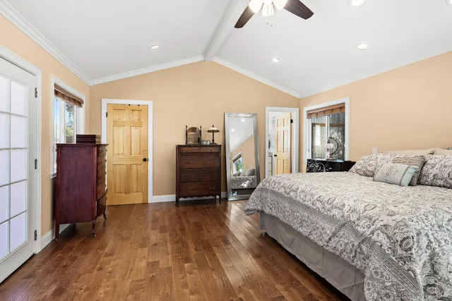 a spacious bedroom with a bed and dresser