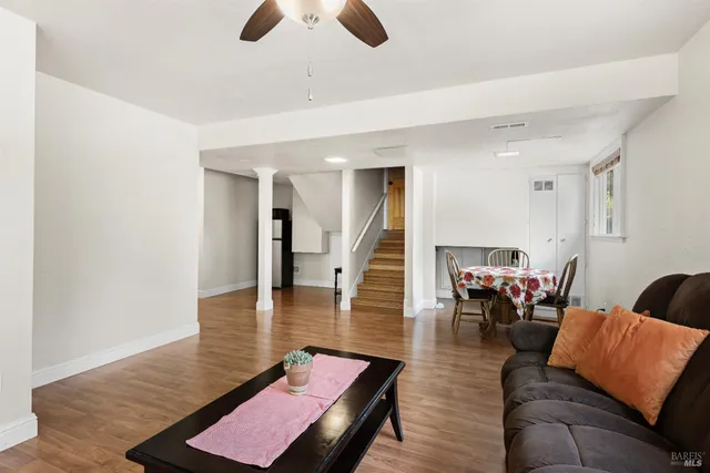 a living room with furniture rug and wooden floor