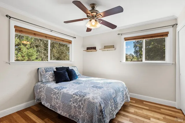 a bed sitting in a bedroom next to a window