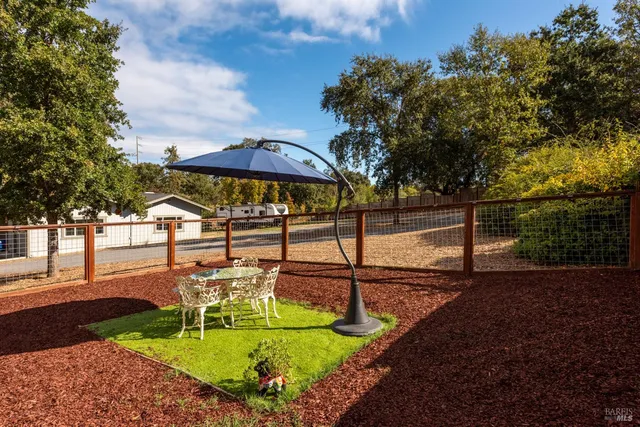 a view of a backyard with sitting area