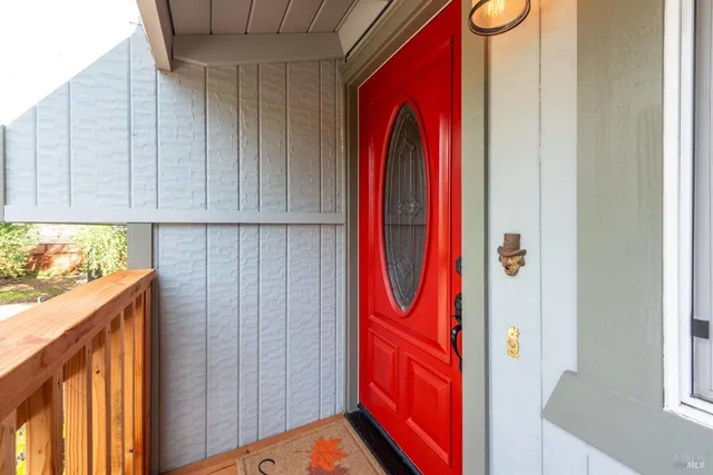 a utility room with stainless steel appliances wooden floor and cabinets