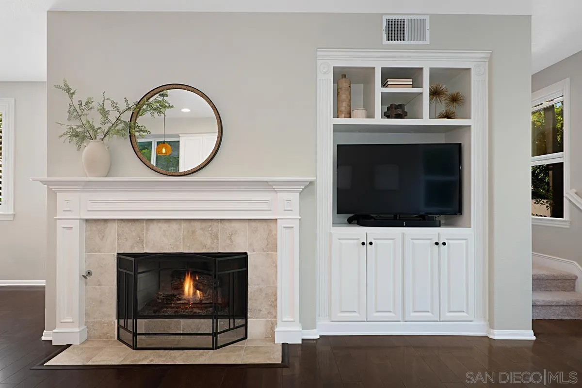 660 Cypress Hills Drive Encinitas, CA 92024 - Photo 12 of 38 a living room with fireplace and a flat screen tv
