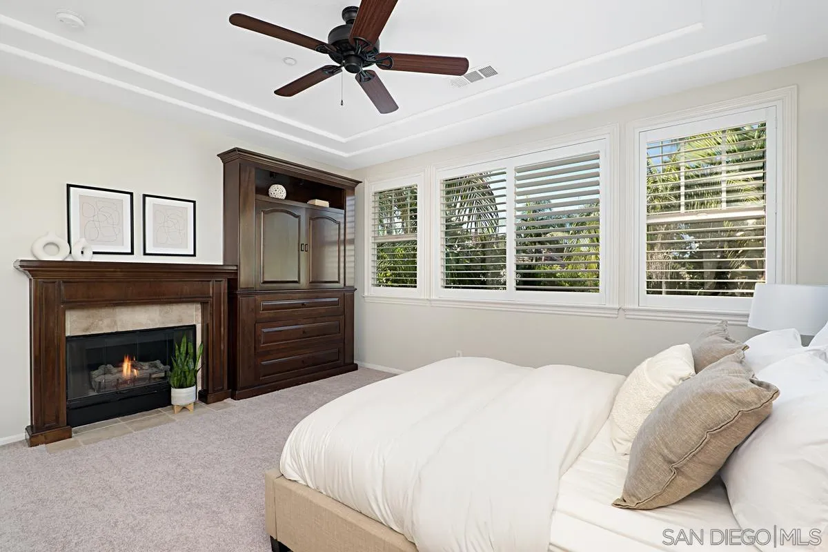 660 Cypress Hills Drive Encinitas, CA 92024 - Photo 14 of 38 a bedroom with a bed and a fireplace