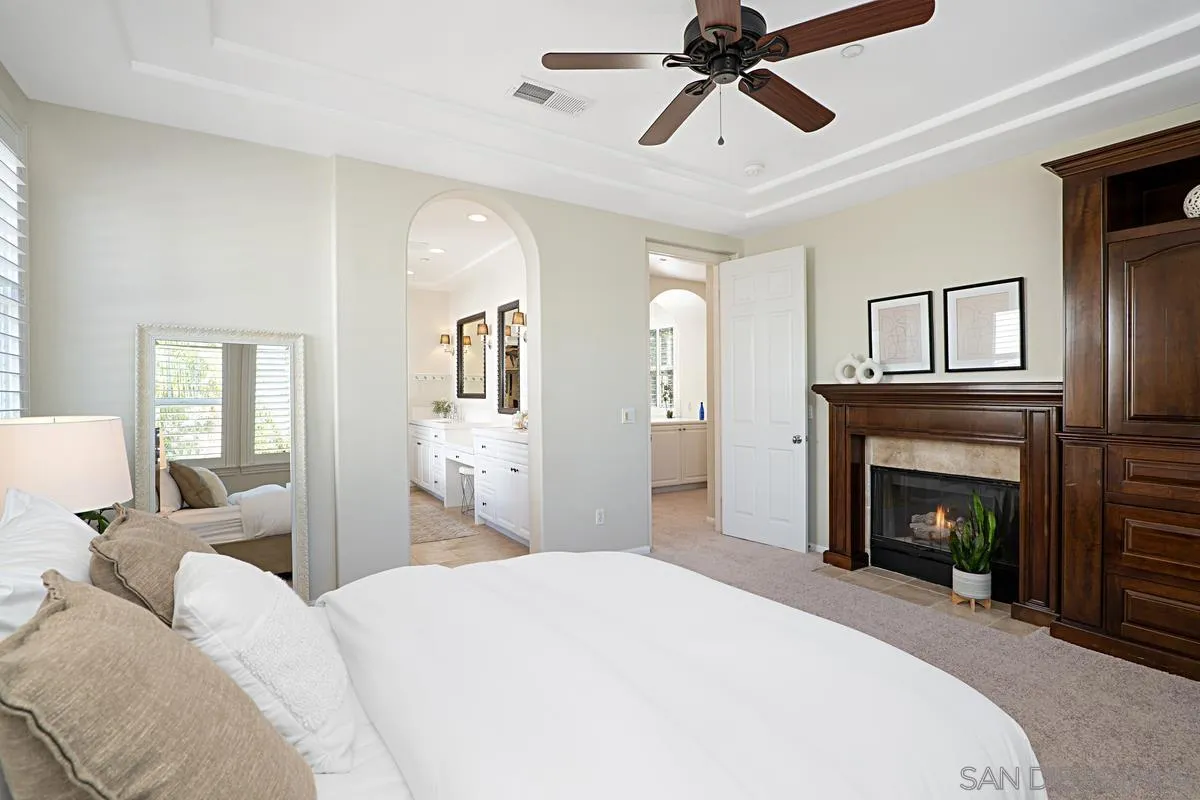 660 Cypress Hills Drive Encinitas, CA 92024 - Photo 15 of 38 a bedroom with a bed and a fireplace