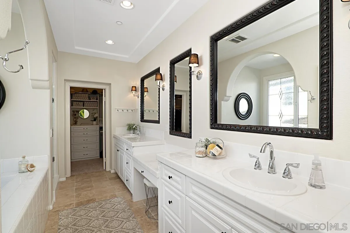 660 Cypress Hills Drive Encinitas, CA 92024 - Photo 16 of 38 a bathroom with a double vanity sink and a mirror
