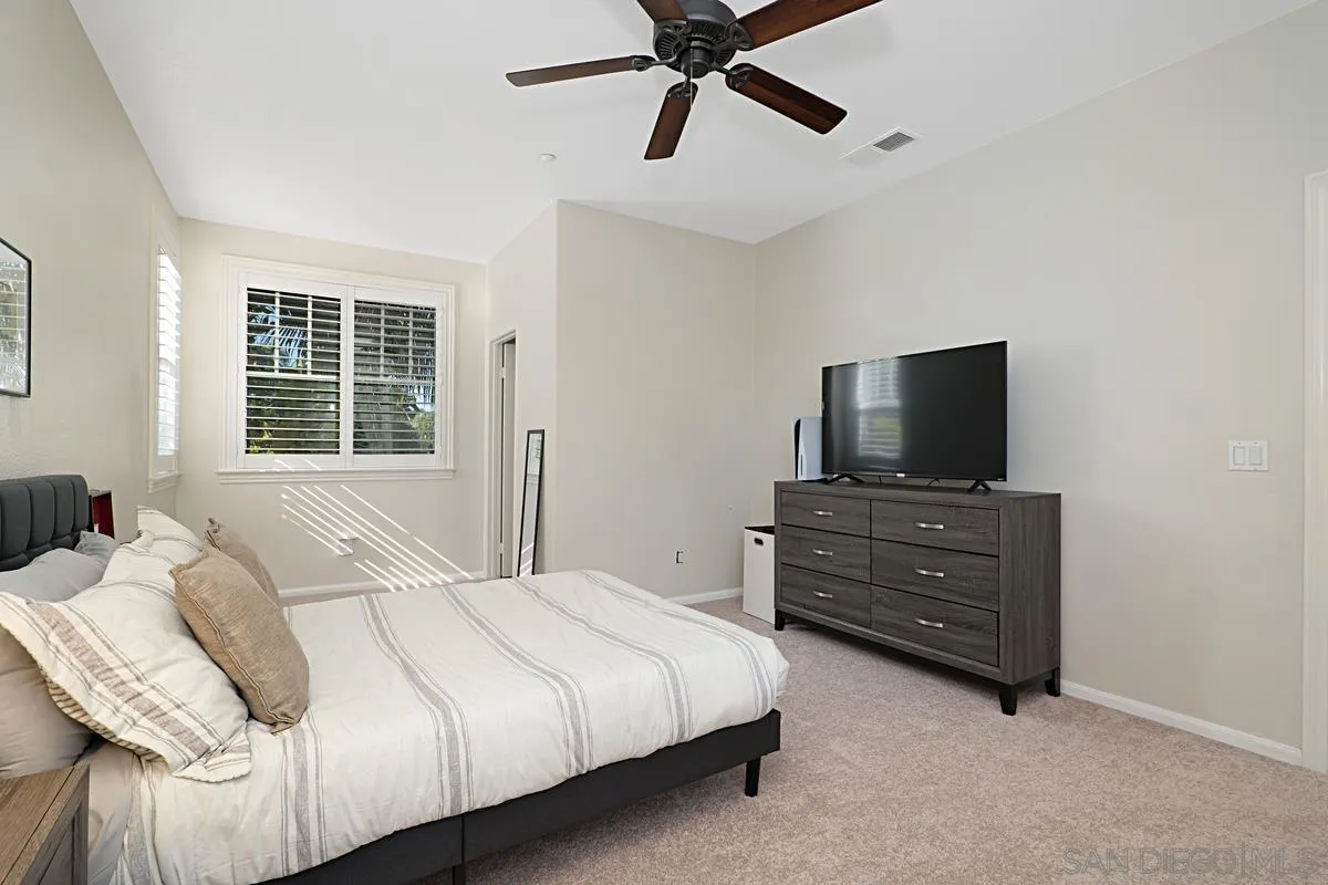 660 Cypress Hills Drive Encinitas, CA 92024 - Photo 28 of 38 a bedroom with a bed and a flat screen tv