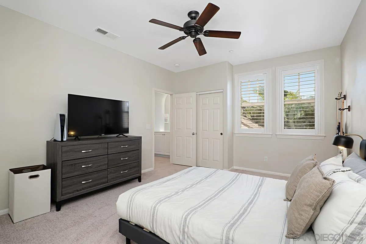 660 Cypress Hills Drive Encinitas, CA 92024 - Photo 30 of 38 a bedroom with a bed a flat screen tv and a window