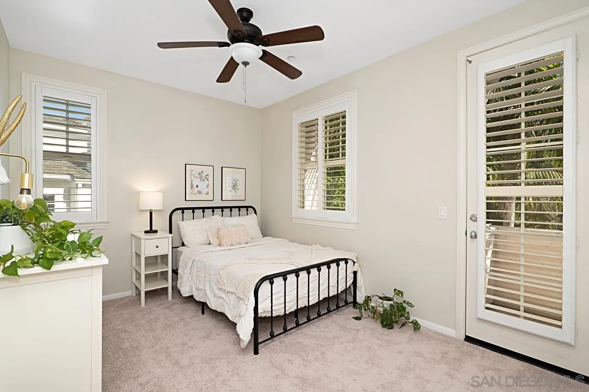 660 Cypress Hills Drive Encinitas, CA 92024 - Photo 31 of 38 a bedroom with a bed chandelier and a window