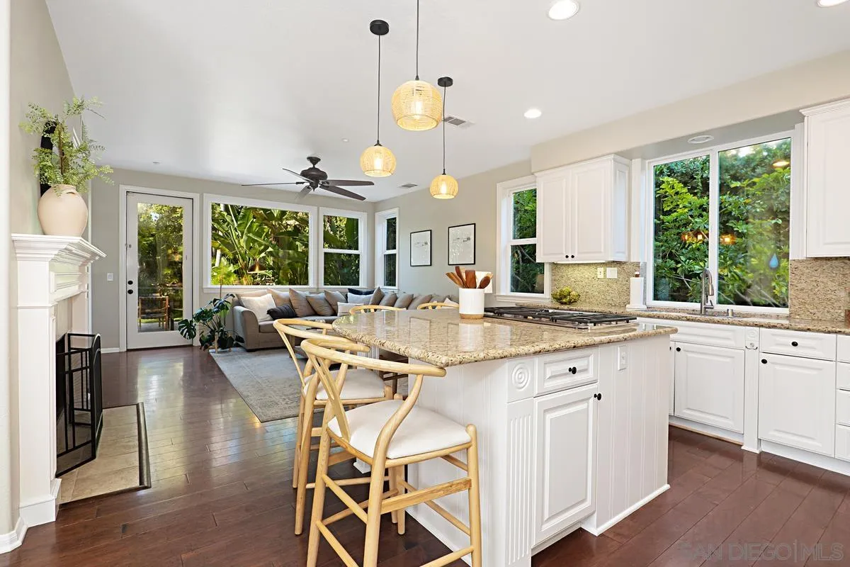 660 Cypress Hills Drive Encinitas, CA 92024 - Photo 7 of 38 a kitchen with stainless steel appliances granite countertop wooden floor and large window