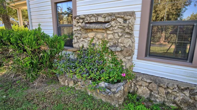 a view of a house with a yard and porch