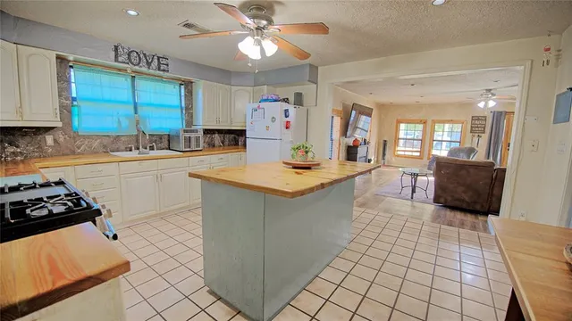 a kitchen with a sink appliances and cabinets