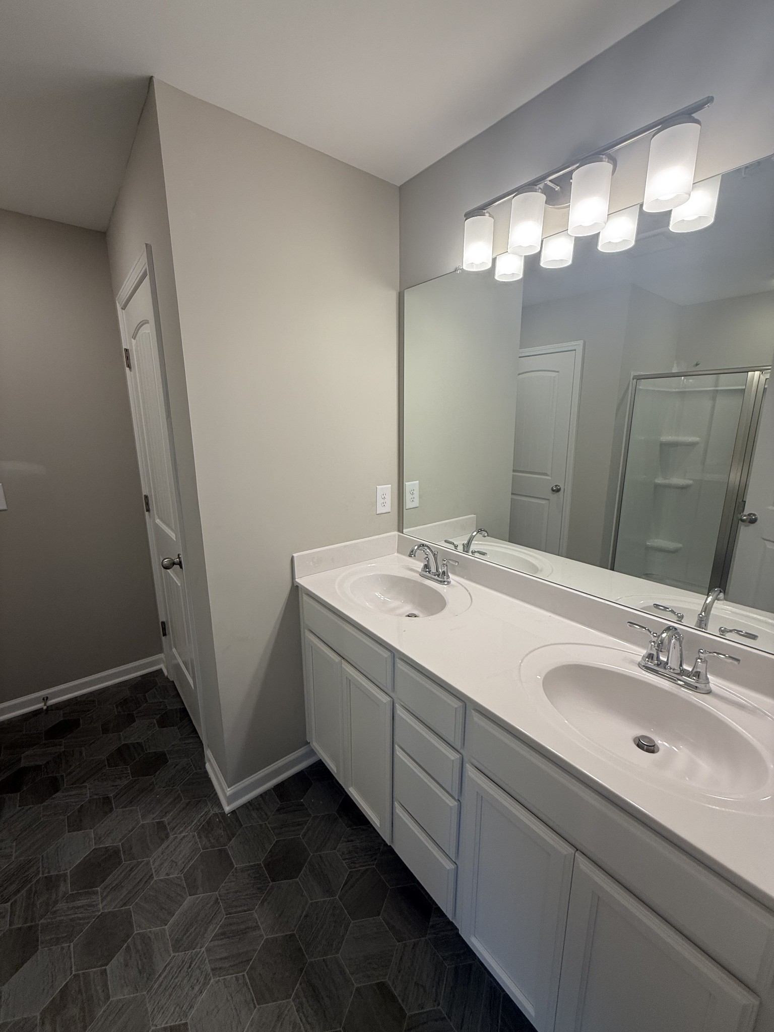 258 Selesia Lane Pleasant View, TN 37146 - Photo 12 of 17 a bathroom with a double vanity sink and a mirror