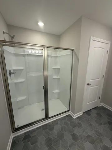 a bathroom with a glass shower door