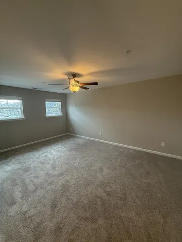 an empty room with a empty space and windows