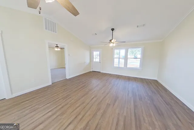 wooden floor in an empty room with a window