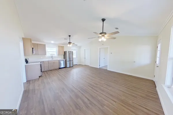 a kitchen with a refrigerator and a stove top oven