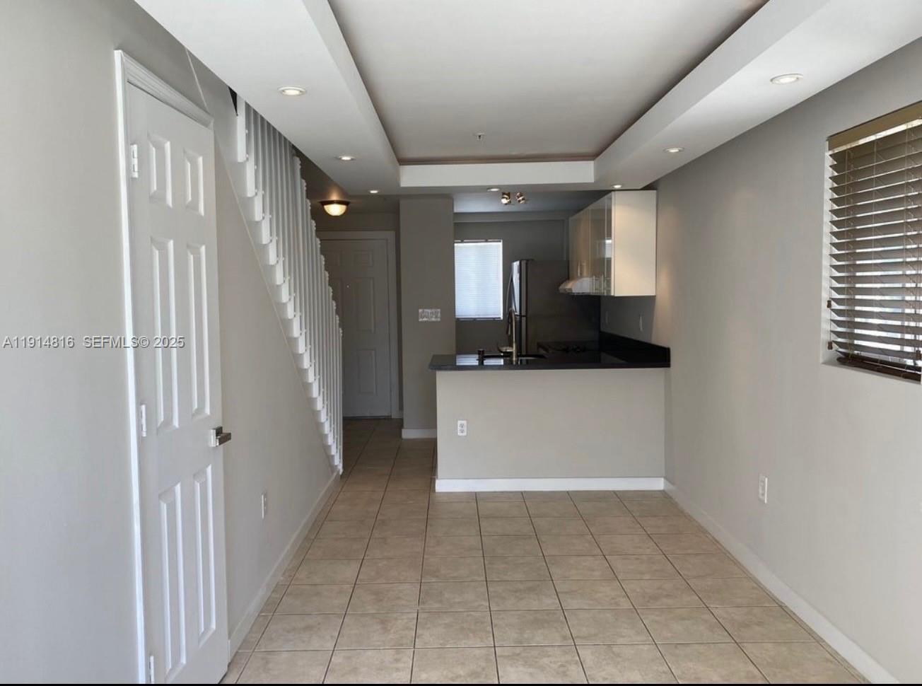 a view of a hallway to rooms and stairs