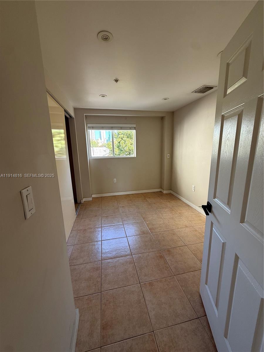 821 Southwest 2nd Street, Unit 1 Miami, FL 33130 - Photo 19 of 28 an empty room with windows and entrance