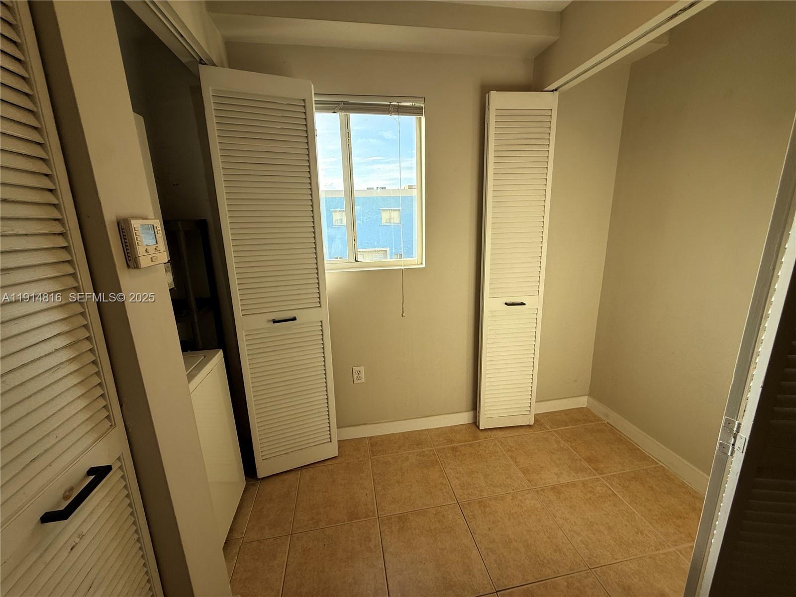 821 Southwest 2nd Street, Unit 1 Miami, FL 33130 - Photo 24 of 28 a view of an empty room with wooden floor and a window