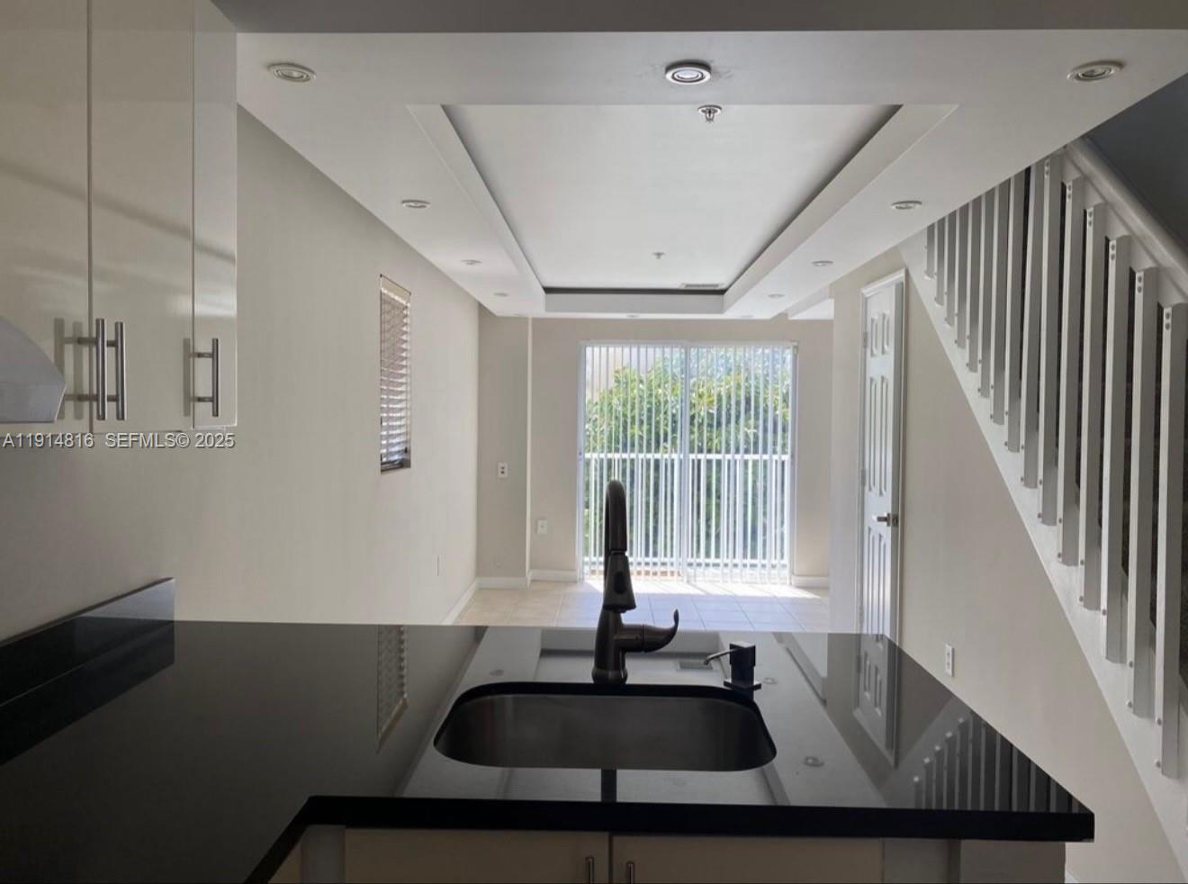 821 Southwest 2nd Street, Unit 1 Miami, FL 33130 - Photo 3 of 28 a view of a livingroom with furniture wooden floor windows and a ceiling fan