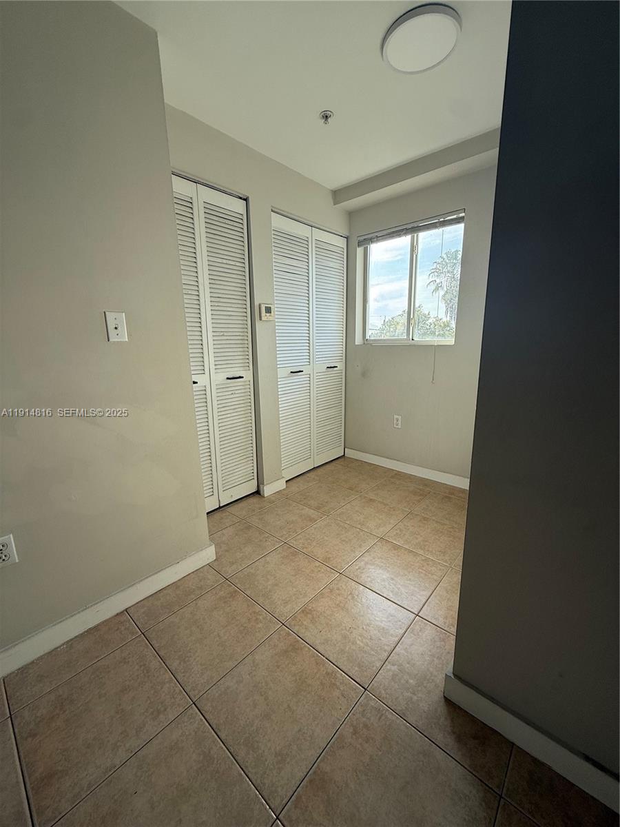 821 Southwest 2nd Street, Unit 1 Miami, FL 33130 - Photo 9 of 28 a view of an empty room and window