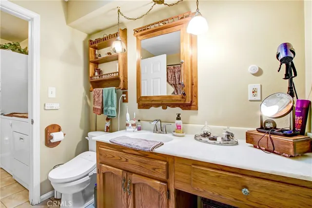 a bathroom with a sink vanity mirror and toilet