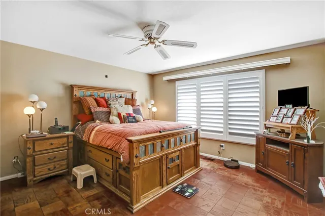 a bedroom with a bed and a tv