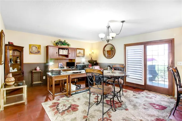 a view of a dining room and livingroom with furniture wooden floor and a rug