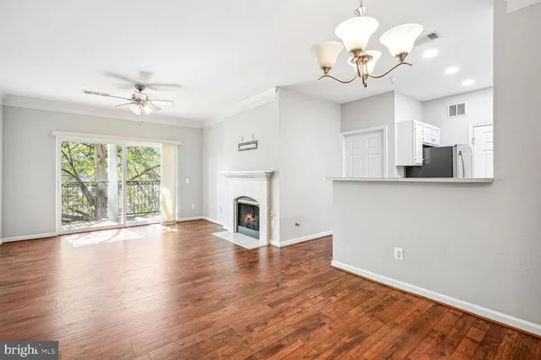 a view of a kitchen with a dishwasher a kitchen island with wooden floor