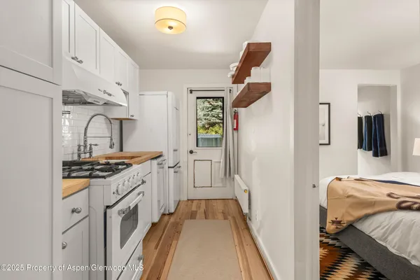 a kitchen with stainless steel appliances granite countertop a stove and a refrigerator