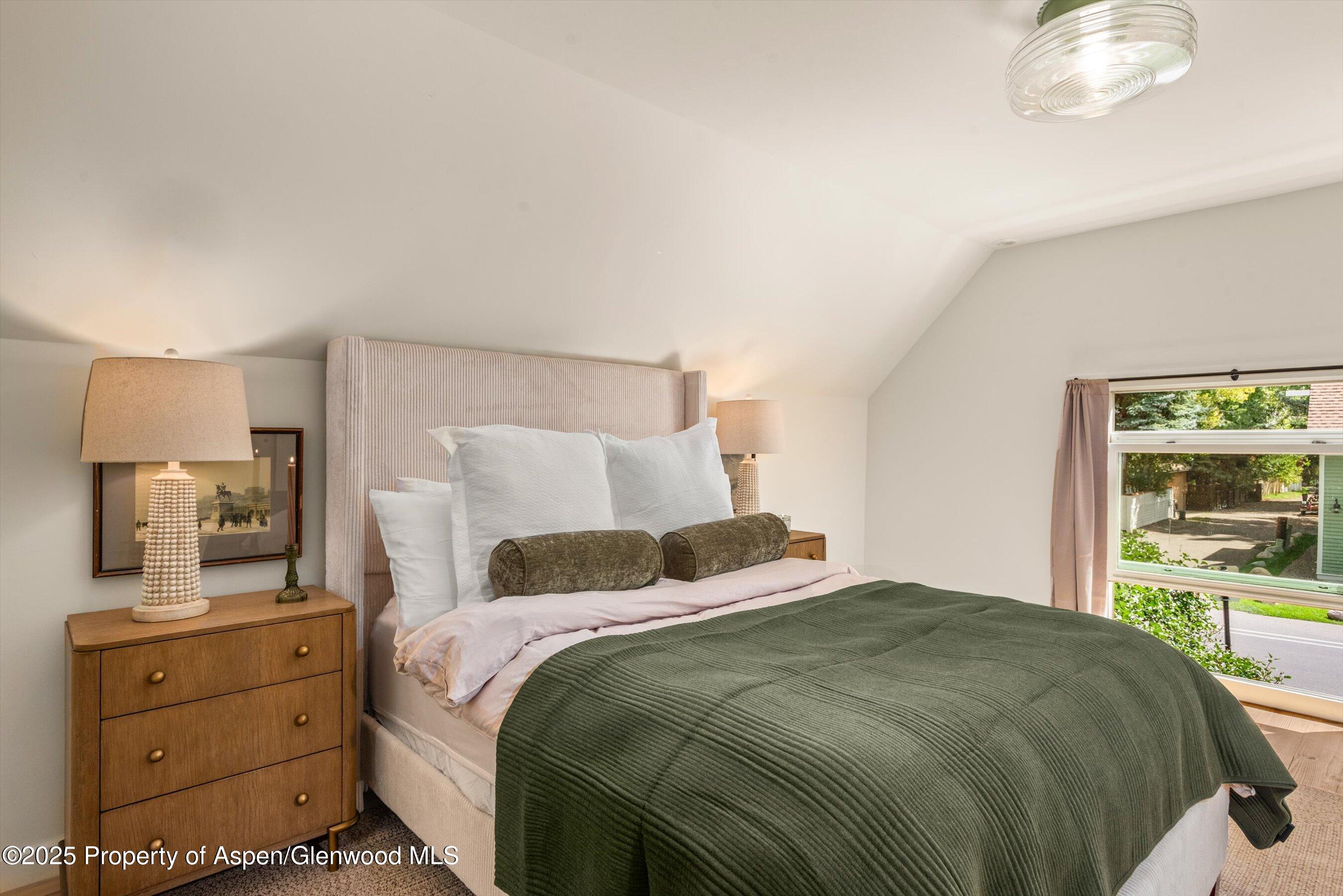500 West Francis Street, Unit CARRIAGE HOUSE Aspen, CO 81611 - Photo 19 of 19 a bedroom with a bed and a large window