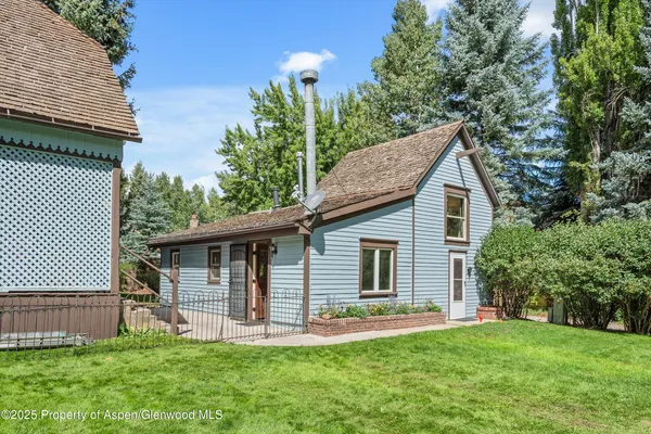 a front view of house with a garden