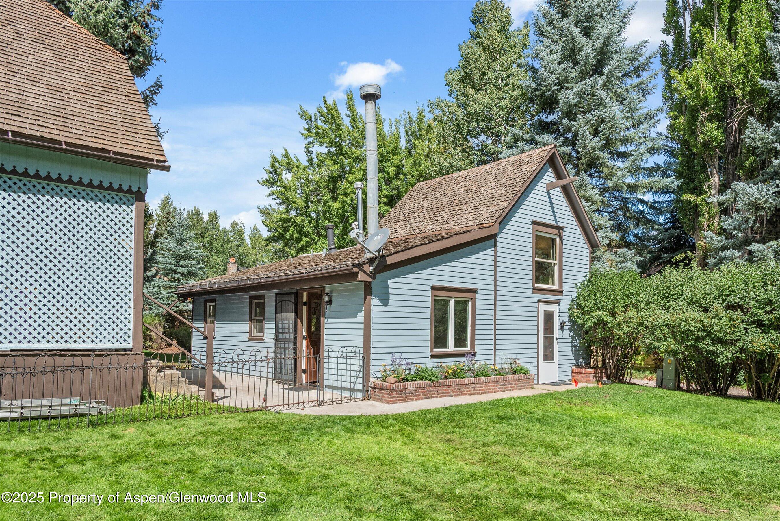 500 West Francis Street, Unit CARRIAGE HOUSE Aspen, CO 81611 - Photo 2 of 19 a front view of house with a garden