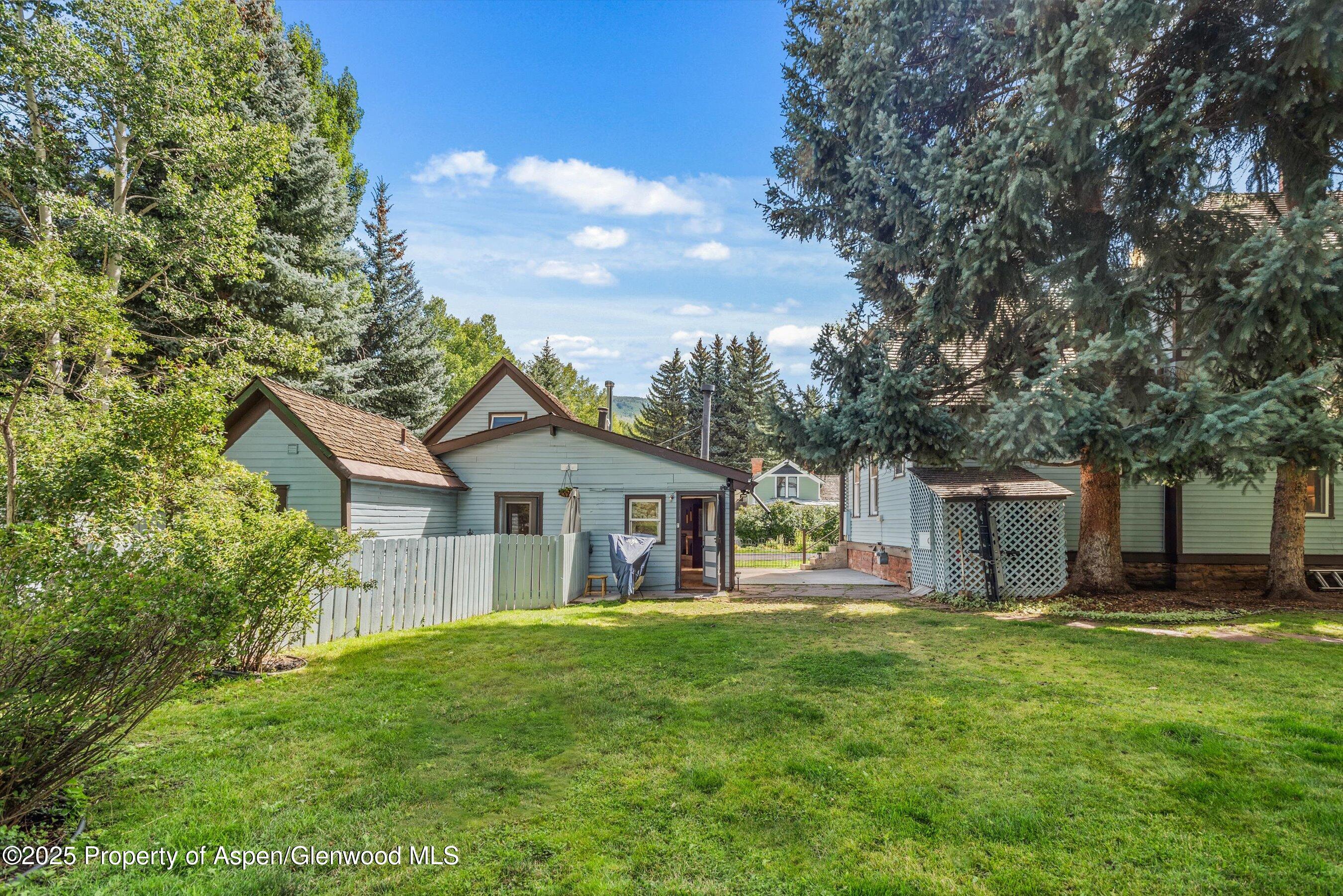 500 West Francis Street, Unit CARRIAGE HOUSE Aspen, CO 81611 - Photo 3 of 19 a front view of house with yard and green space