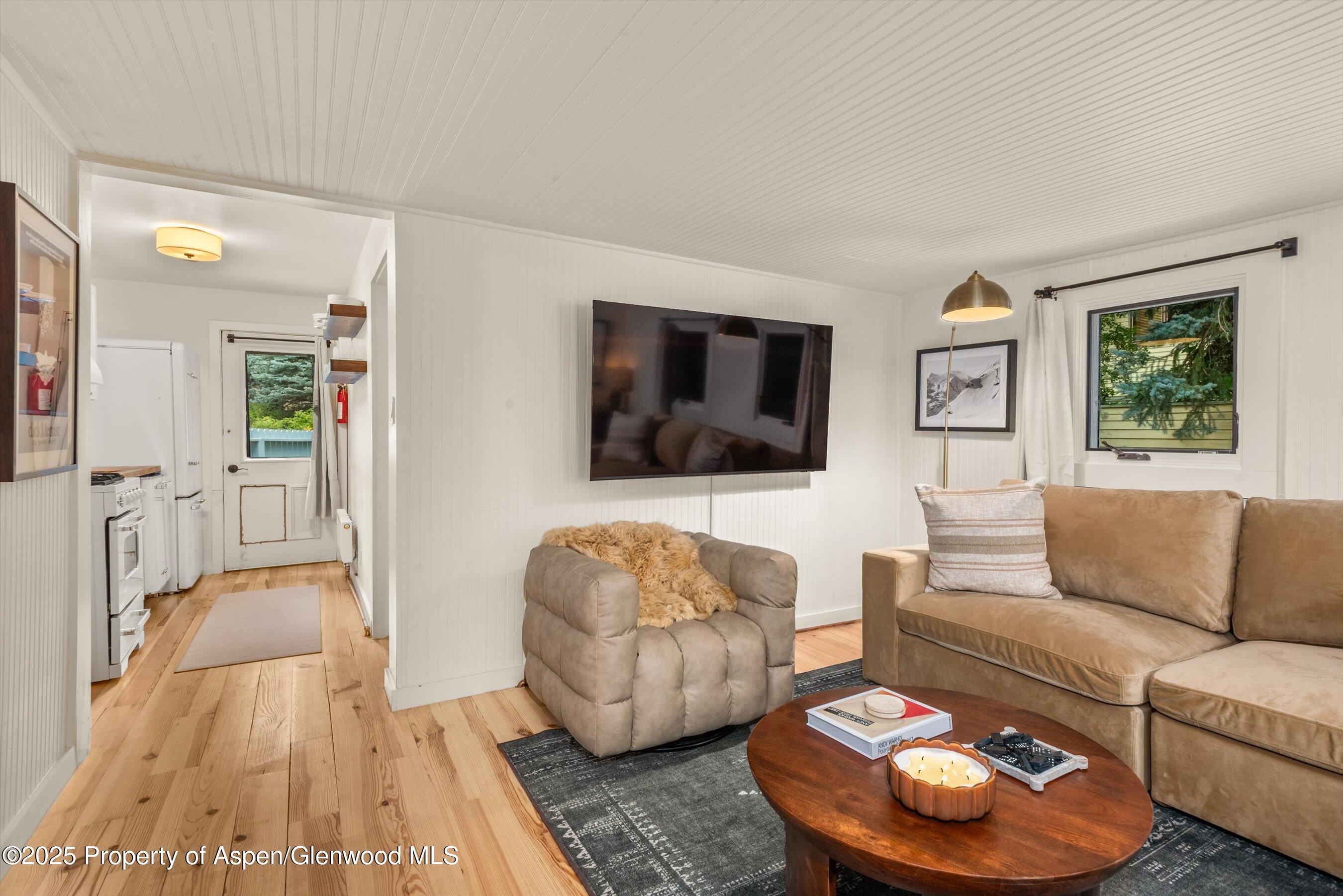 500 West Francis Street, Unit CARRIAGE HOUSE Aspen, CO 81611 - Photo 7 of 19 a living room with furniture and a flat screen tv