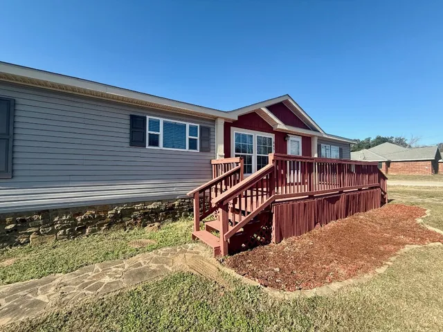 a kitchen with stainless steel appliances kitchen island granite countertop a table chairs in it and a counter space