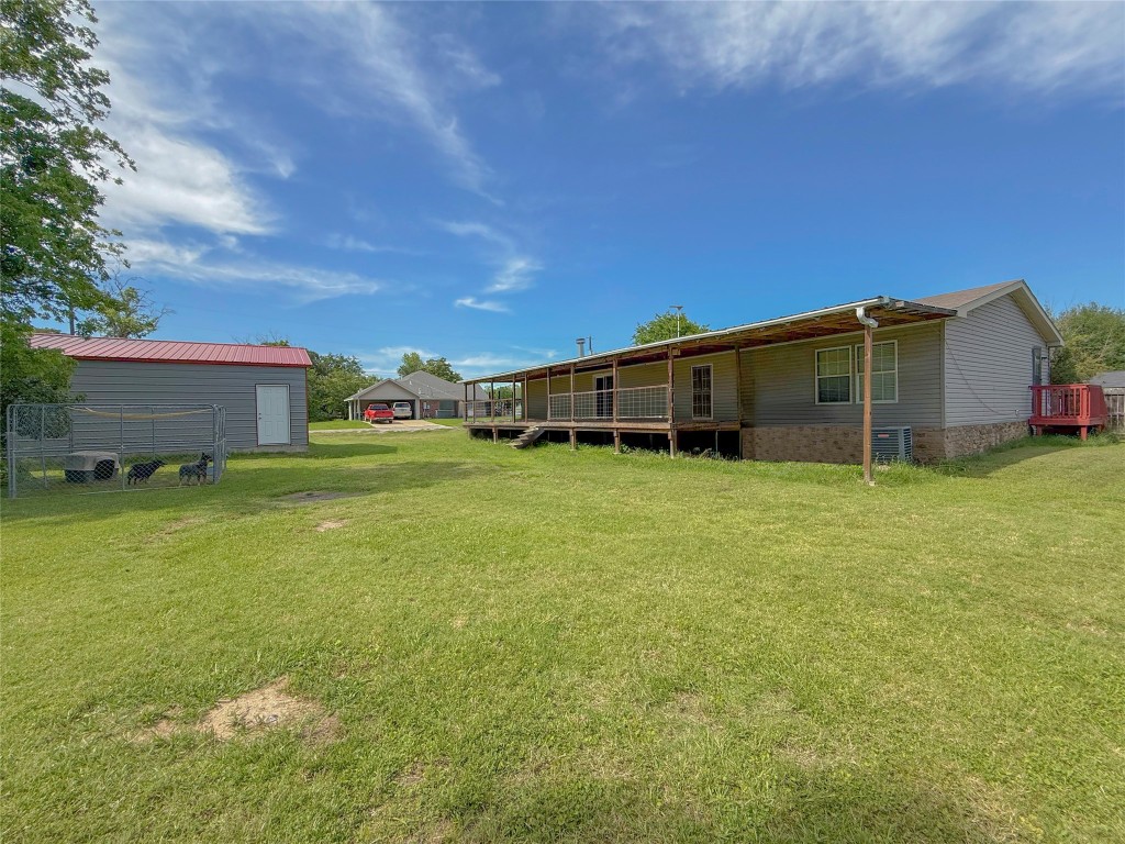 845 Caldwell Street Lexington, TX 78947 - Photo 25 of 39 View of grassy yard with a wooden deck