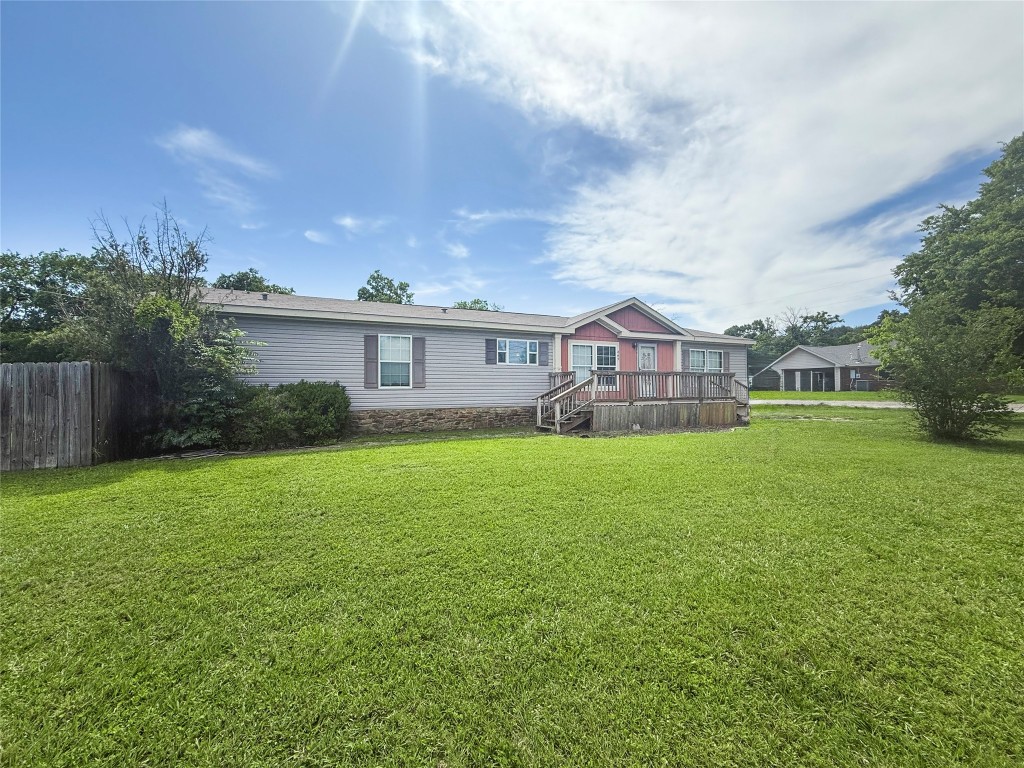 845 Caldwell Street Lexington, TX 78947 - Photo 26 of 39 a view of a house next to a big yard and large trees