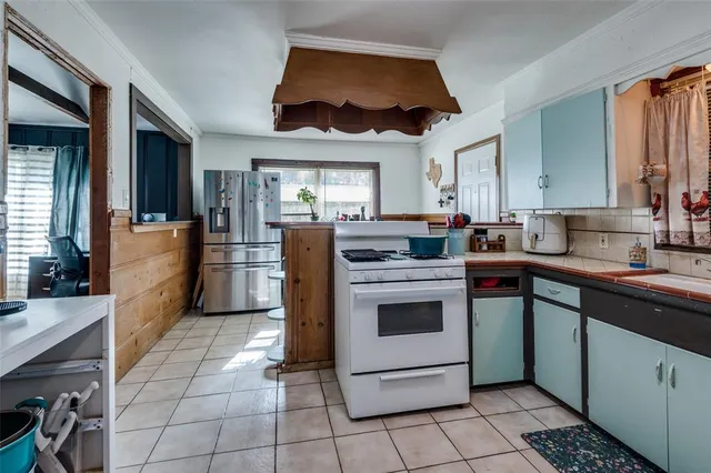 a kitchen with a sink appliances and cabinets