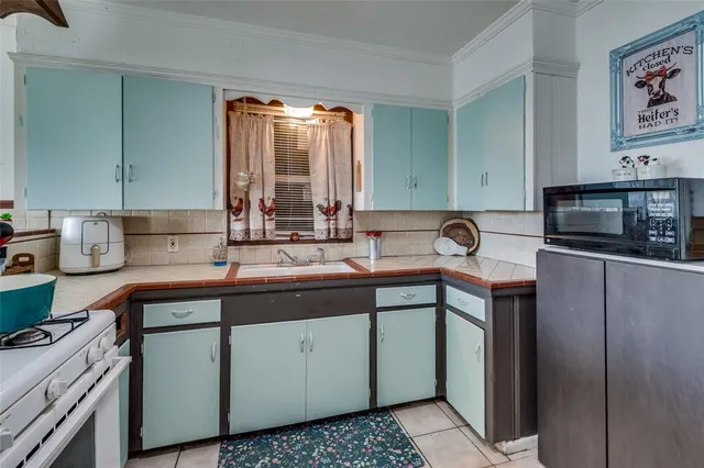 a kitchen with a sink and cabinets